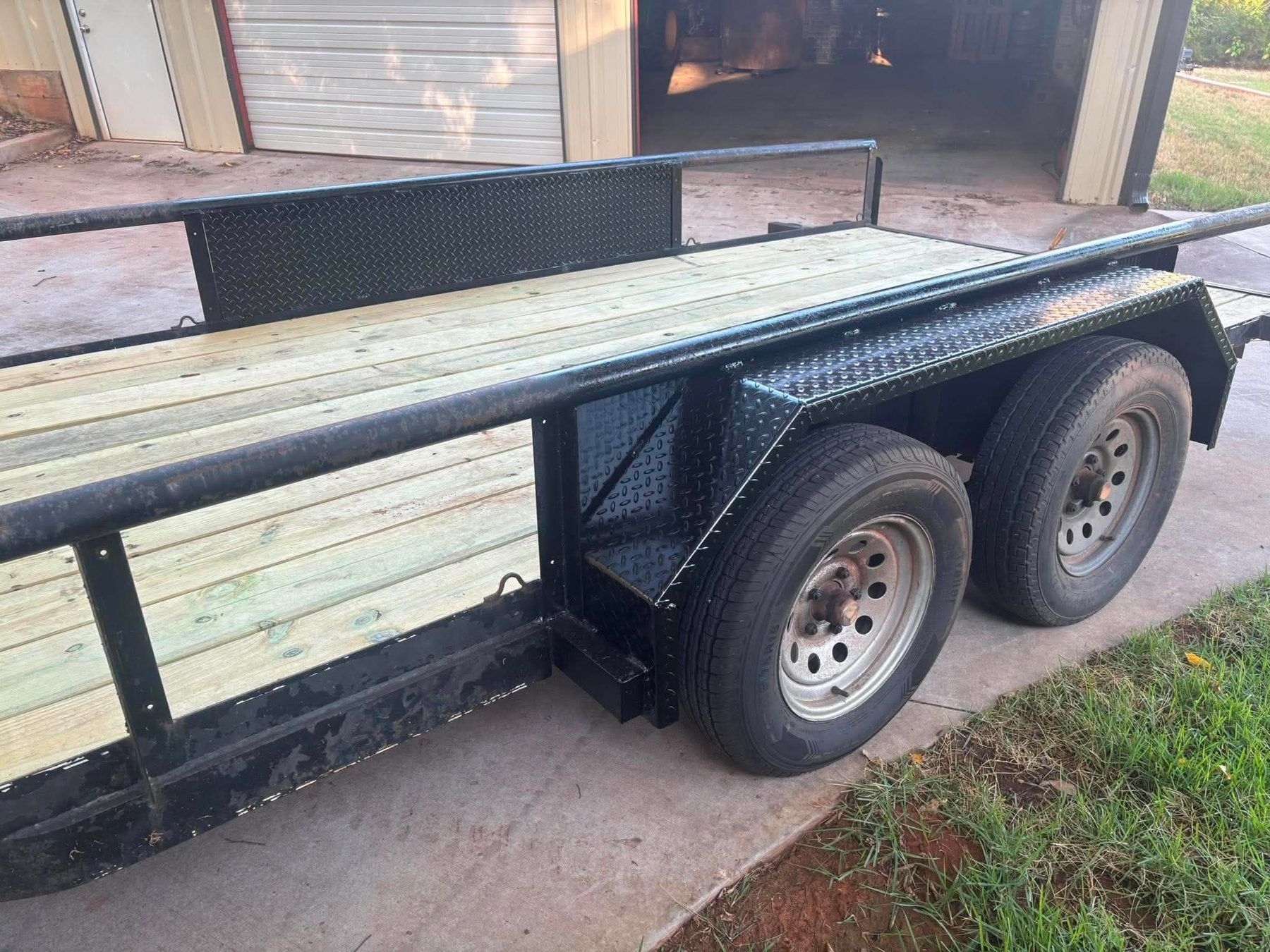 Drive over fenders running the length of a utility trailer deck in 3/16 inch diamond tread plate